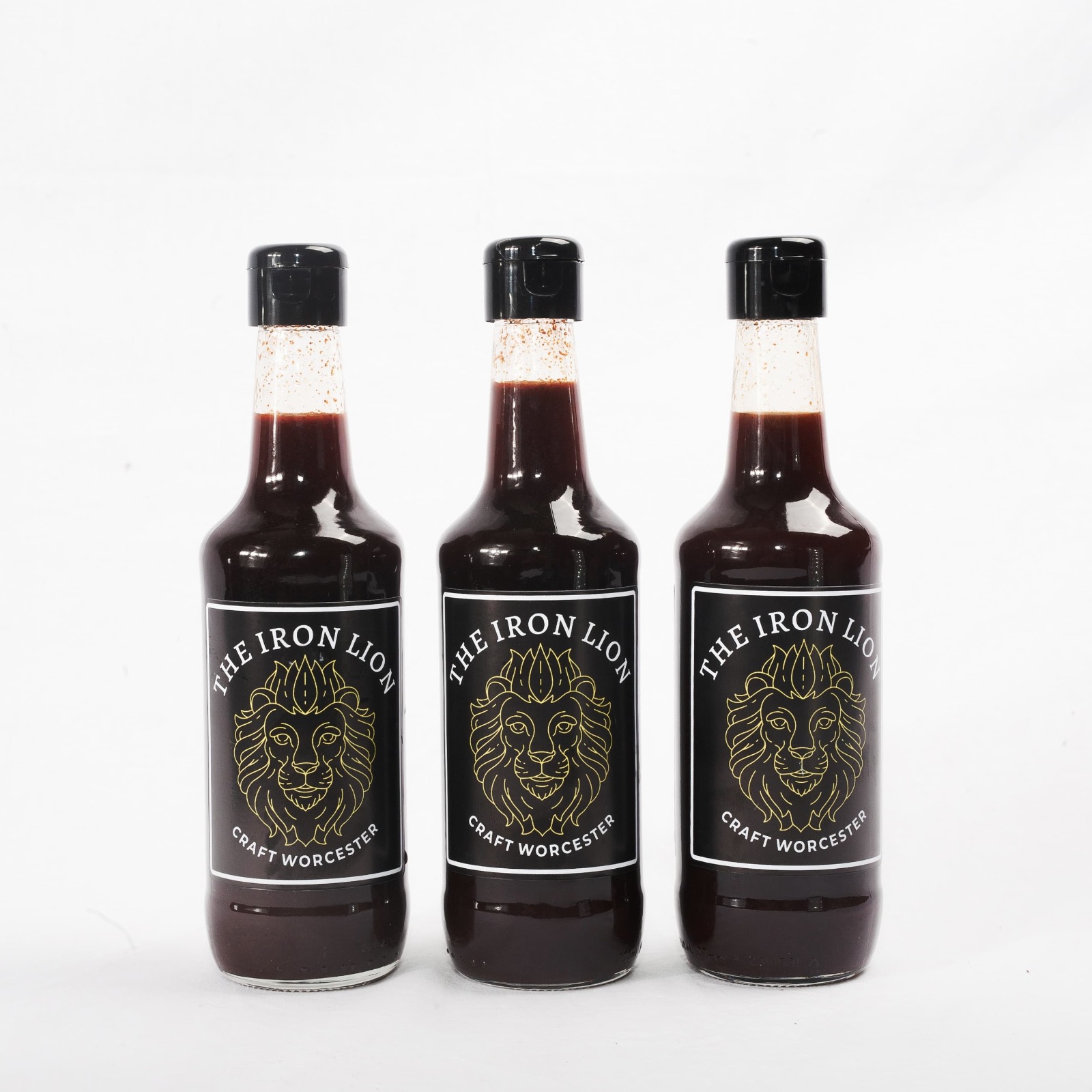Three bottles of The Iron Lion Worcester Sauce